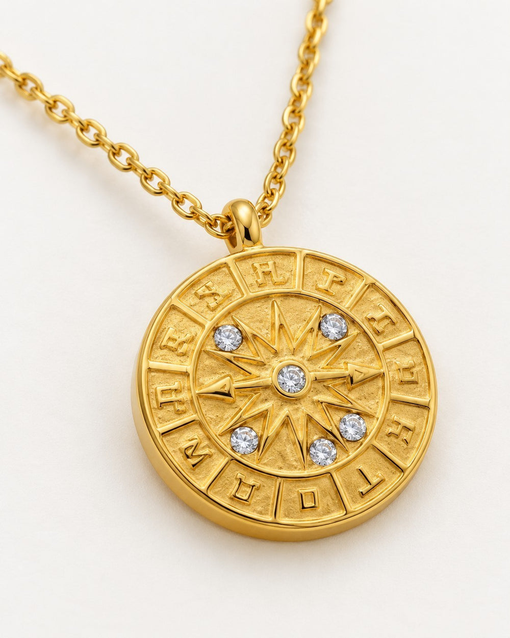 Elli Jewellery gold plated coin pendant necklace featuring a celestial compass pointer design with crystal accents.
