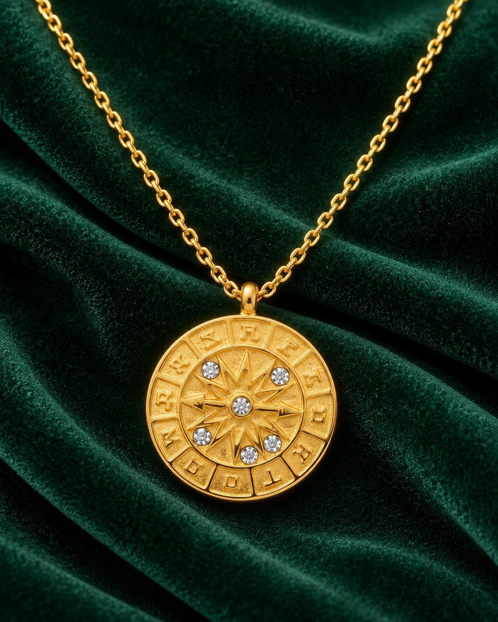 Elli Jewellery gold plated coin pendant necklace featuring a celestial compass pointer design with crystal accents.