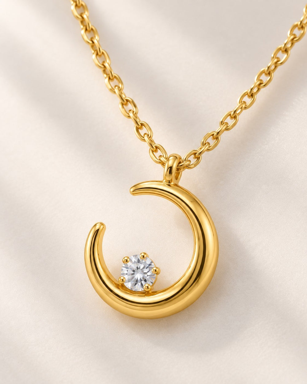 Elli Jewellery gold plated crescent moon pendant necklace with a central sparkling stone on a delicate chain