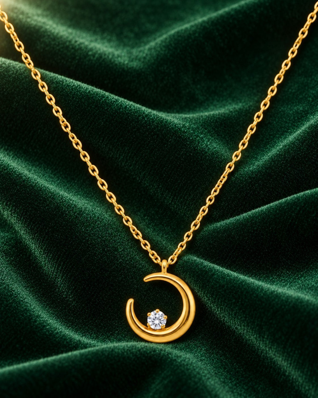 Elli Jewellery gold plated crescent moon pendant necklace with a central sparkling stone on a delicate chain
