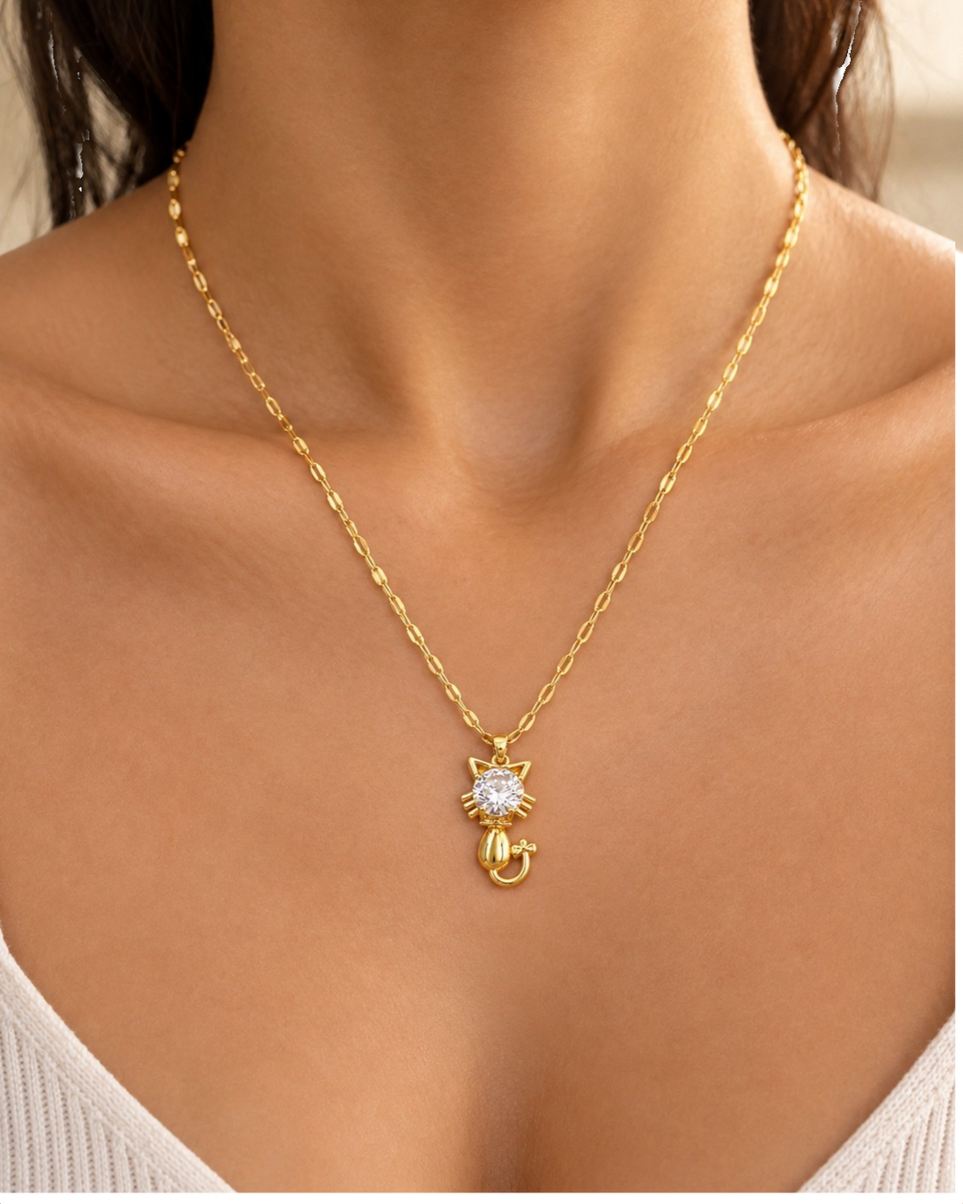 Elli Jewellery gold plated cat pendant necklace featuring a sparkling crystal on a delicate chain worn on a model
