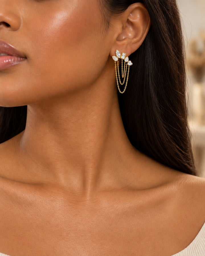 Elli Jewellery gold plated drop earrings featuring a cluster of mixed-cut crystals and delicate hanging chains.
