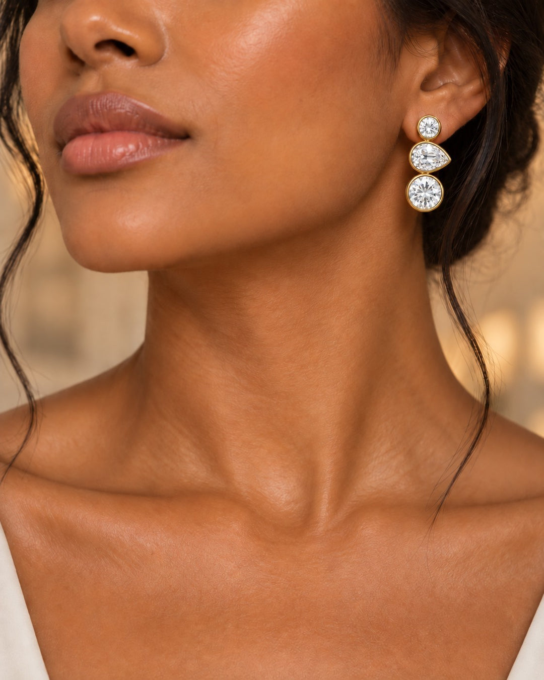 Elli Jewellery triple crystal drop earrings in 18ct gold plating with bezel-set cubic zirconia on a model