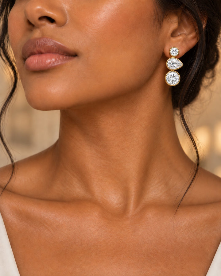 Elli Jewellery triple crystal drop earrings in 18ct gold plating with bezel-set cubic zirconia on a model