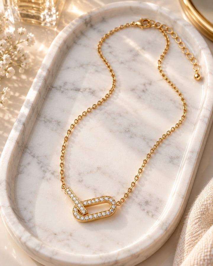 Elli Jewellery gold plated waterproof chunky link chain necklace with crystal accents on a marble tray