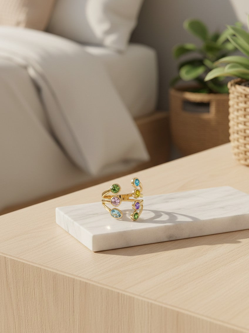 Elli Jewellery gold plated statement ring with seven vibrant bezel-set crystals in a sculptural spiral design