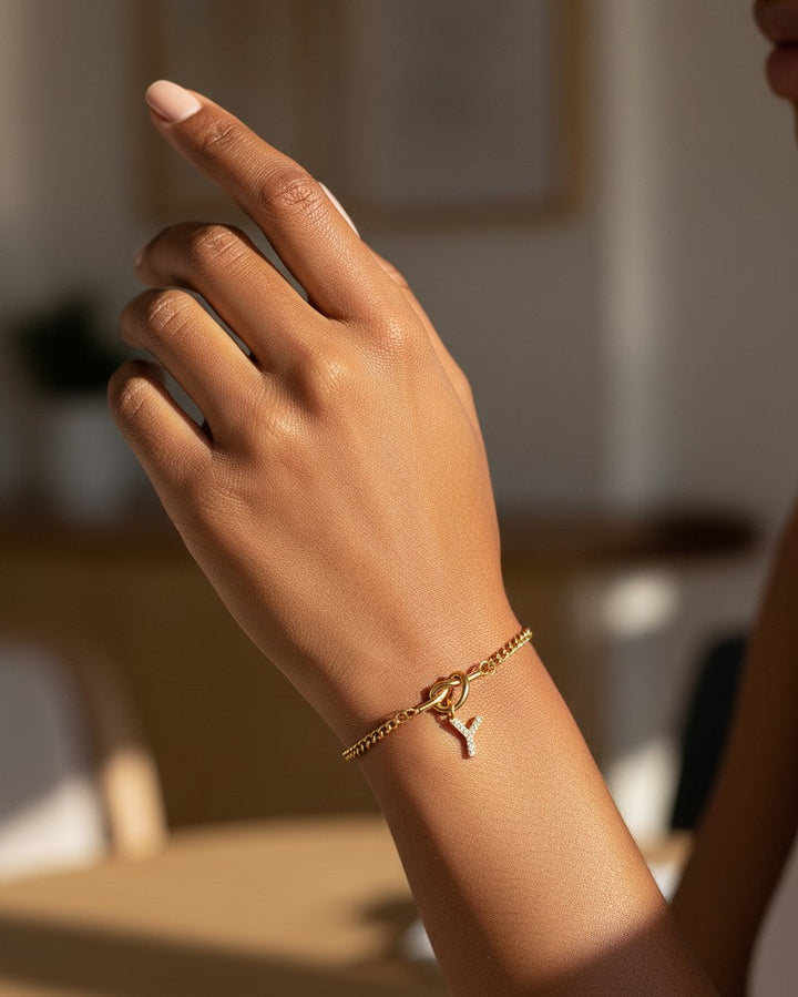 Elli Jewellery gold plated chain bracelet featuring a sparkling crystal letter Y charm worn on a woman's wrist
