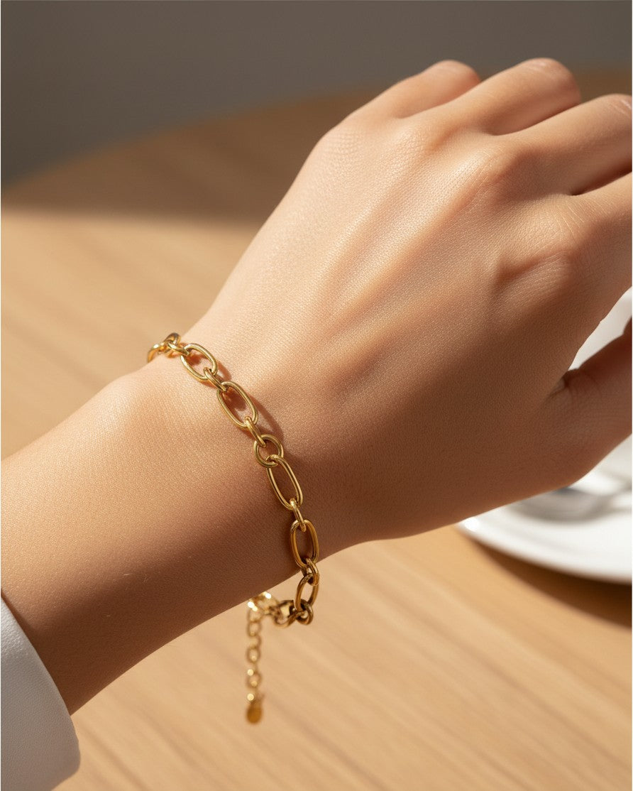 Elli Jewellery gold plated waterproof Cuban link chain bracelet worn on a wrist with a high-shine finish