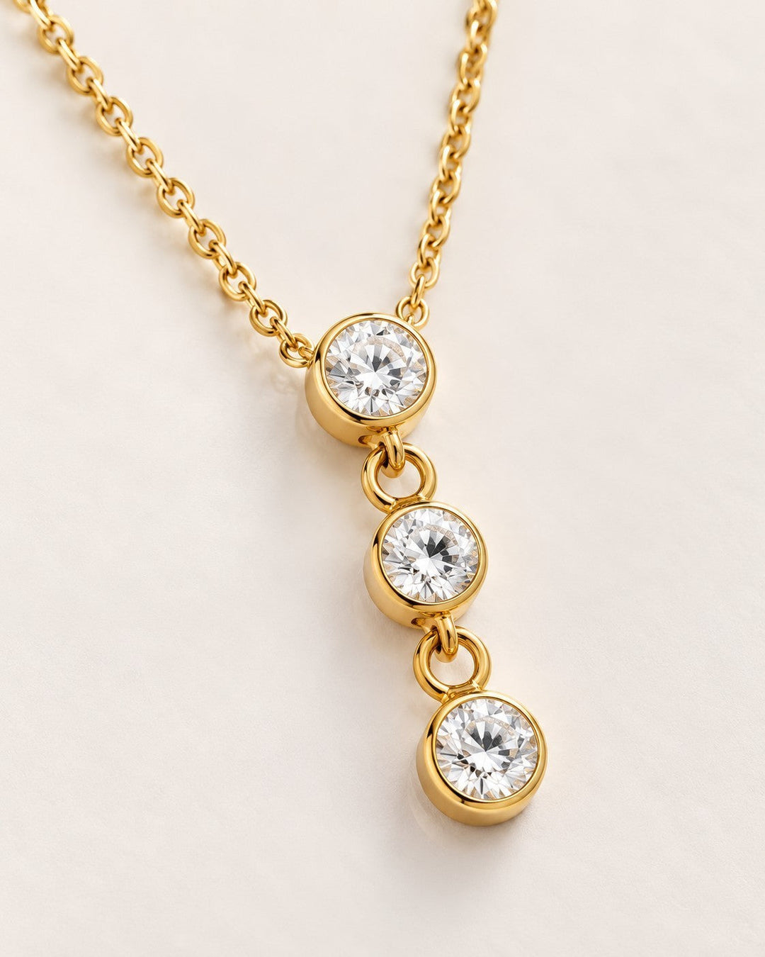 Elli Jewellery dainty gold plated necklace featuring three bezel-set cubic zirconia crystals on a delicate chain