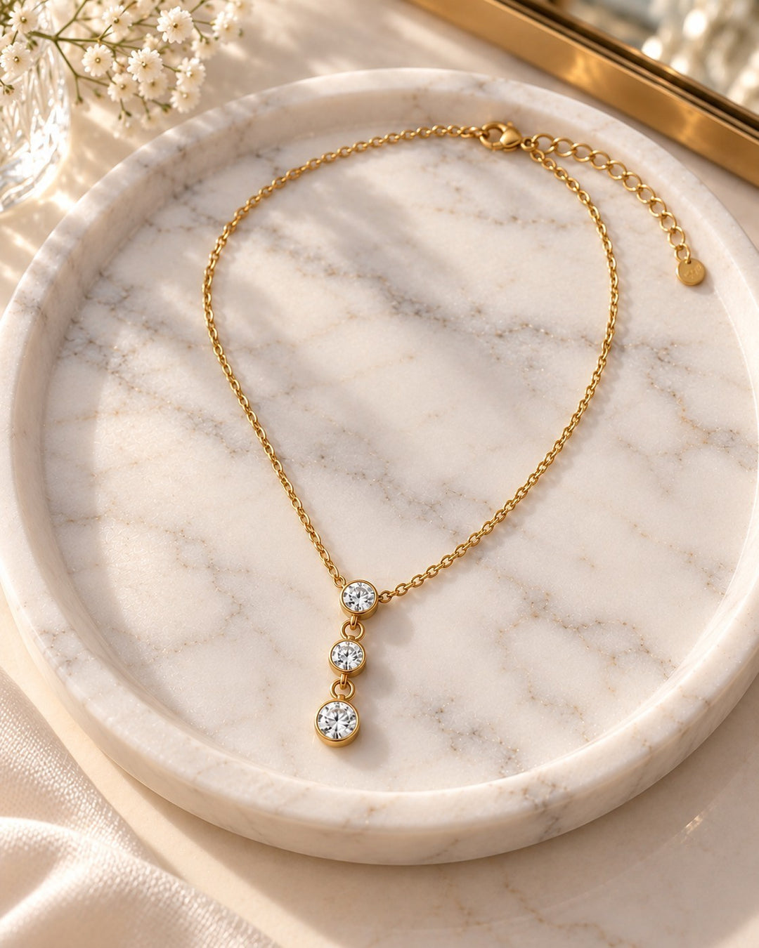 Elli Jewellery dainty gold plated necklace featuring three sparkling cubic zirconia stones on a delicate chain.