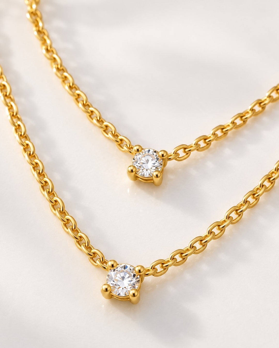 Elli Jewellery gold plated waterproof necklace featuring two delicate chains with sparkling cubic zirconia pendants.