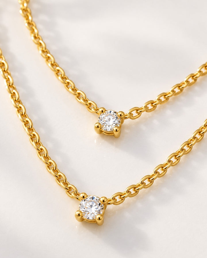 Elli Jewellery gold plated waterproof necklace featuring two delicate chains with sparkling cubic zirconia pendants.