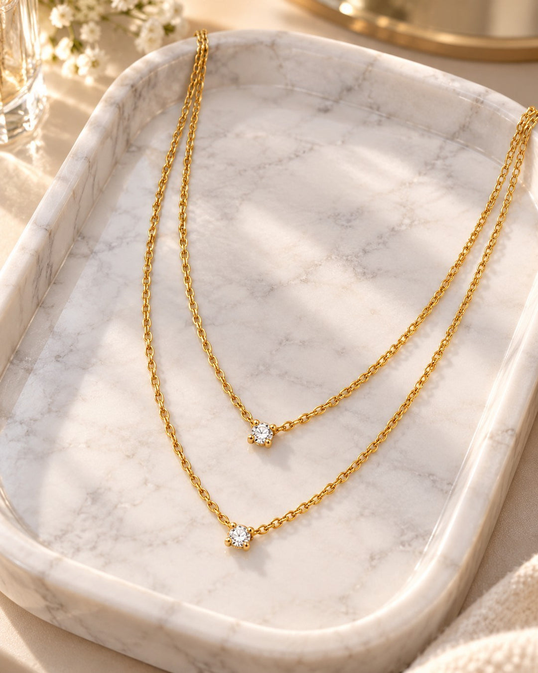 Elli Jewellery gold plated waterproof necklace featuring two delicate chains with sparkling cubic zirconia pendants.