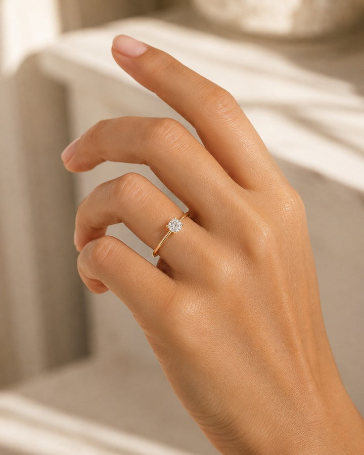 Elli Jewellery gold-toned ring featuring a single brilliant-cut cubic zirconia stone on a delicate band.