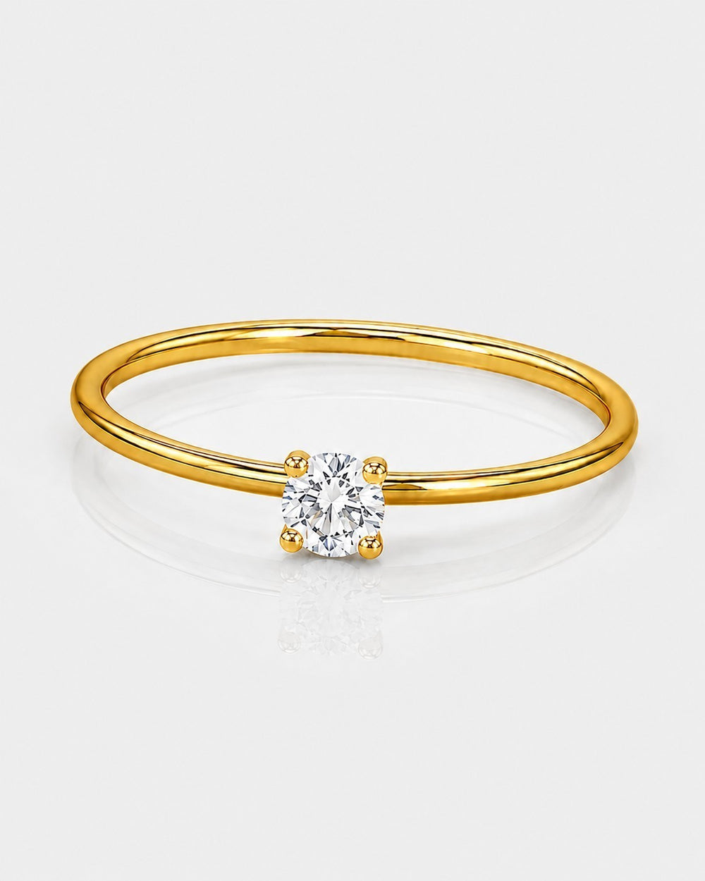 Elli Jewellery gold-toned solitaire ring featuring a single brilliant-cut cubic zirconia stone on a thin band.