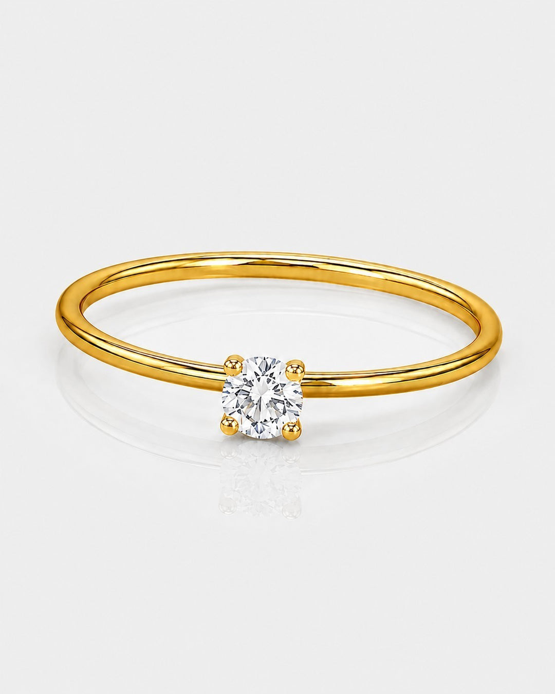 Elli Jewellery gold-toned solitaire ring featuring a single brilliant-cut cubic zirconia stone on a thin band.