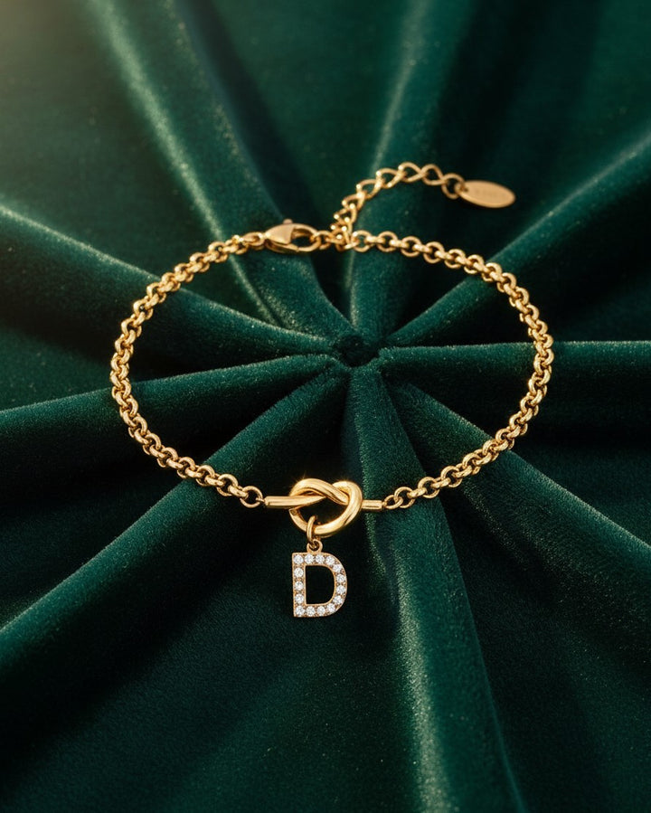 Elli Jewellery gold plated waterproof chain bracelet with a crystal diamante D initial charm on green velvet