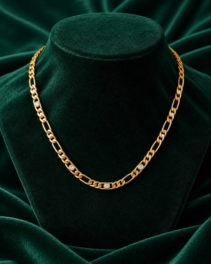 Elli Jewellery gold plated waterproof chain necklace featuring embedded diamante crystals on a green velvet display