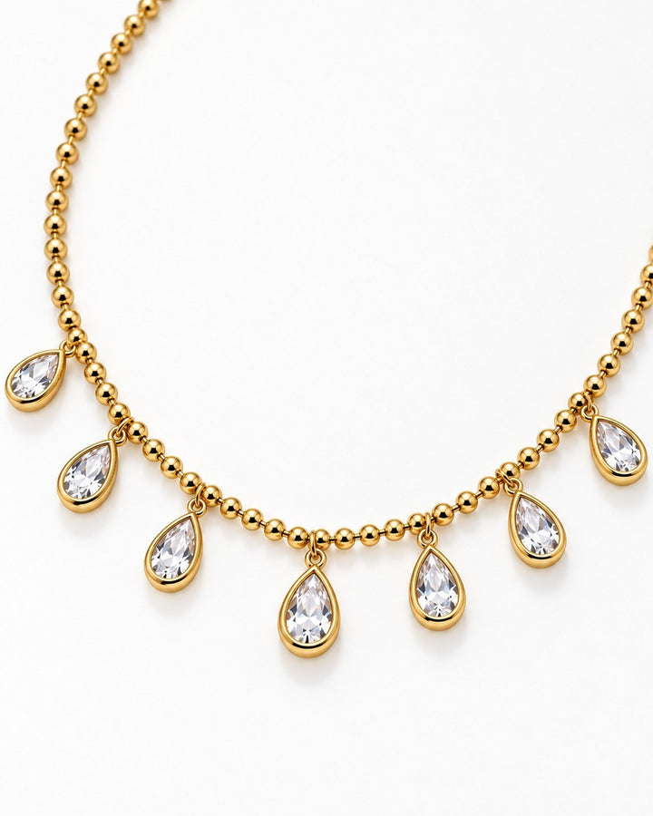 Elli Jewellery gold plated chain necklace featuring dangling pear-shaped diamante crystals on a beaded gold chain.