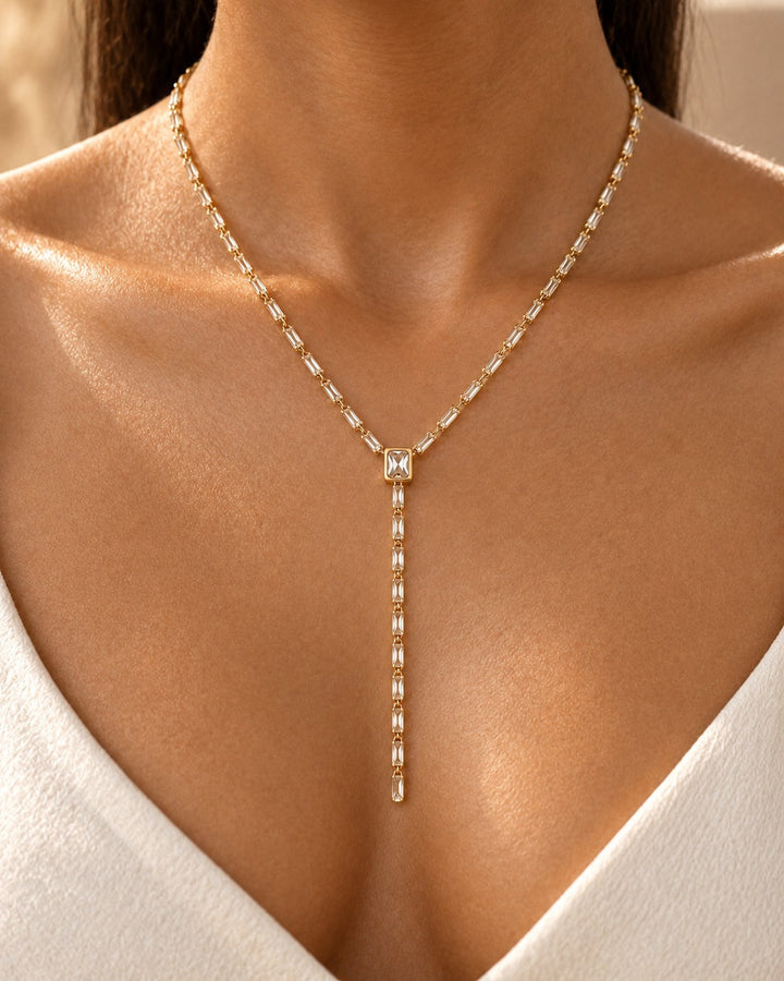 Elli Jewellery gold-plated long necklace featuring a central square stone and baguette-cut diamante crystal chain.