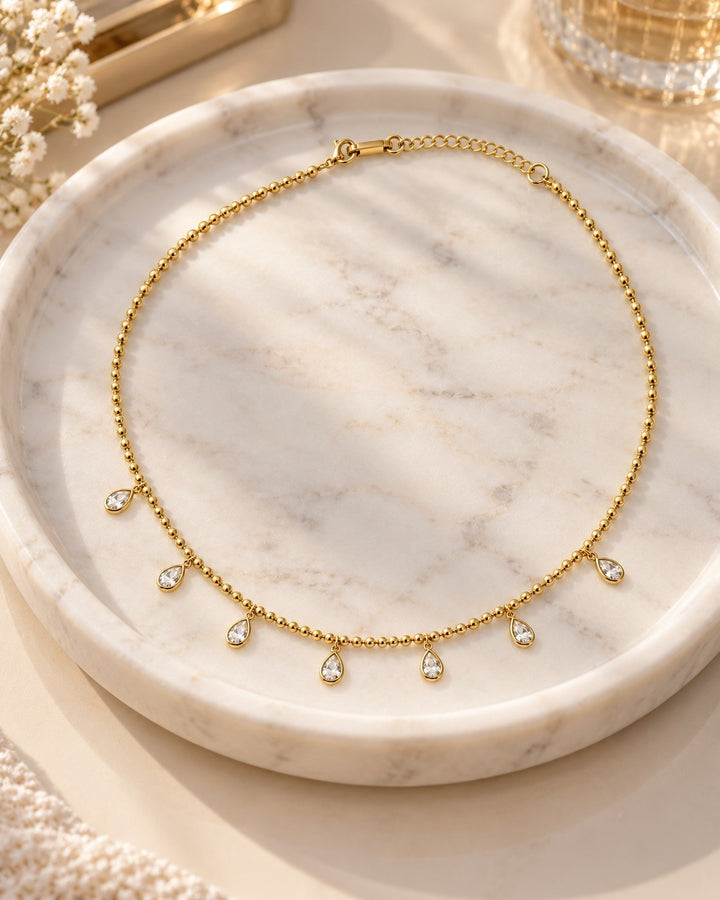 Elli Jewellery gold plated chain necklace featuring delicate bead links and dangling pear-shaped diamante crystals.
