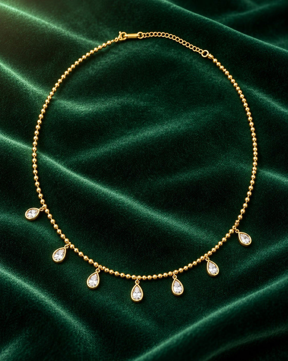Elli Jewellery gold plated chain necklace featuring delicate bead links and dangling pear-shaped diamante charms