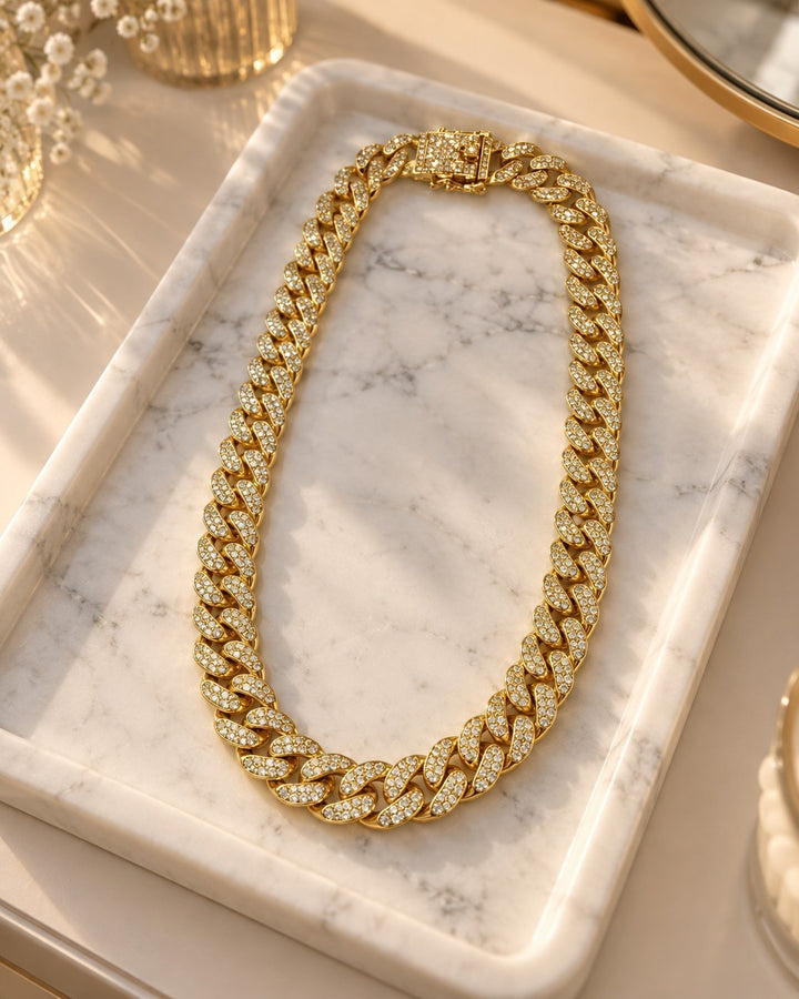 Elli Jewellery gold-plated chunky curb chain necklace featuring sparkling diamante crystals on a marble tray