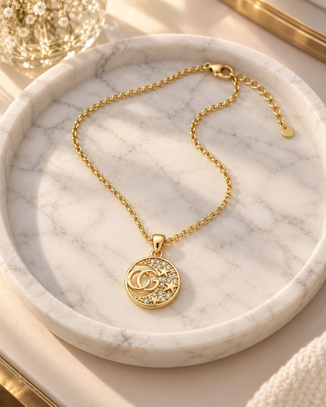 Elli Jewellery gold plated necklace with a round CG initial pendant featuring sparkling diamante crystals and stars.