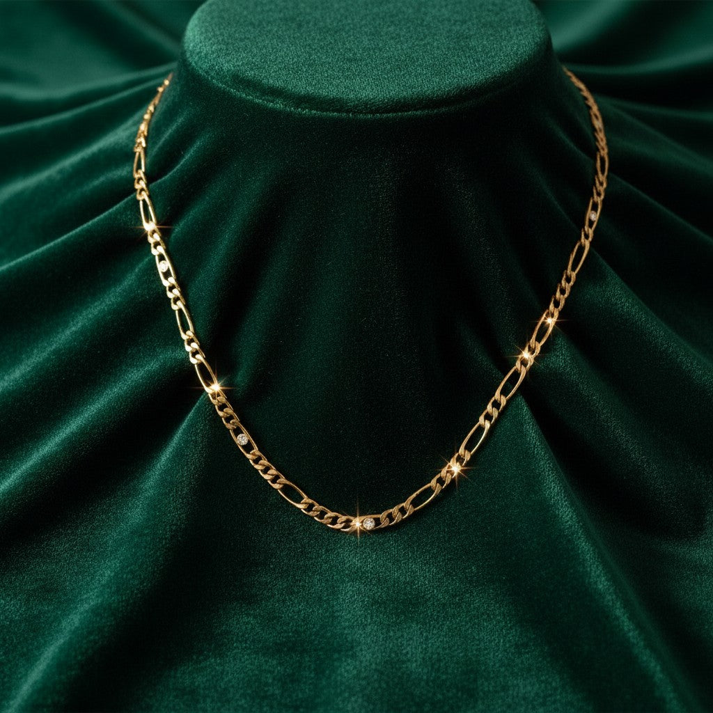 Elli Jewellery gold plated link chain necklace featuring sparkling diamante crystal accents on dark green velvet.