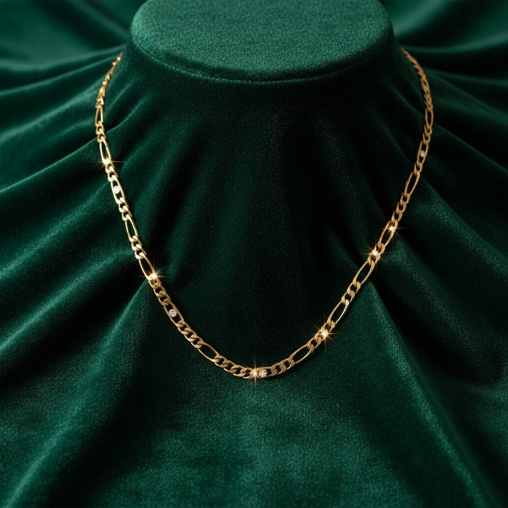 Elli Jewellery gold plated link chain necklace featuring sparkling diamante crystal accents on dark green velvet.