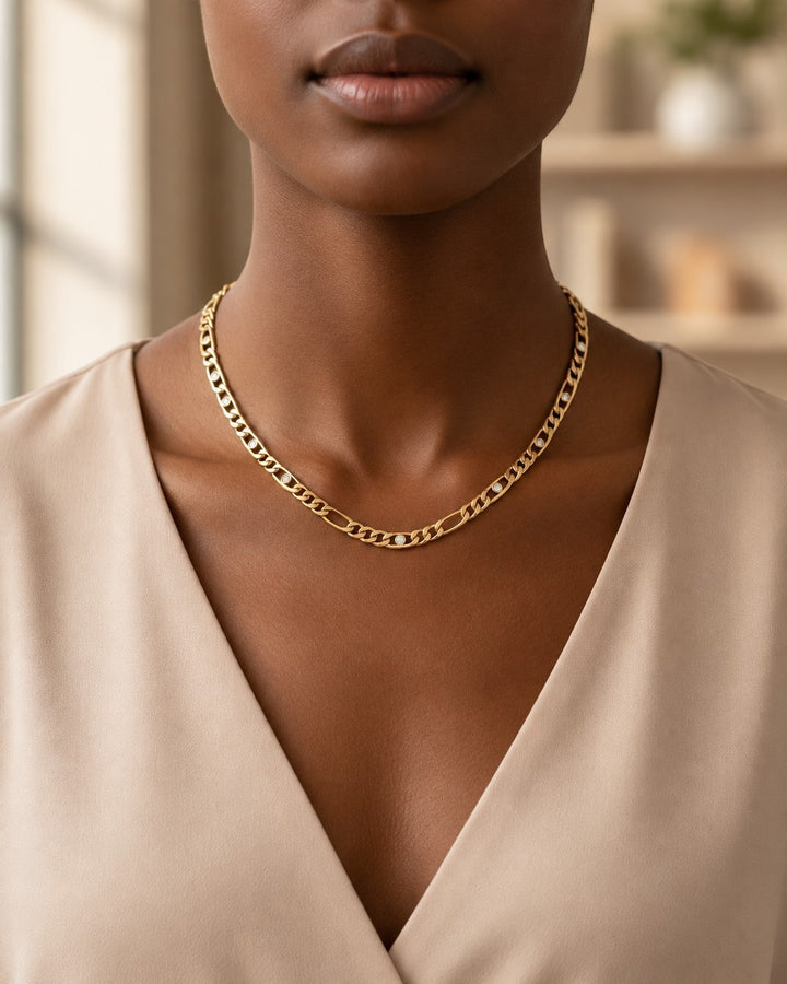 Elli Jewellery gold plated link chain necklace with diamante crystals worn by a model in a beige top