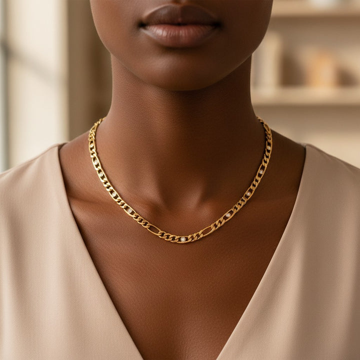 Elli Jewellery gold plated link chain necklace with diamante crystal accents worn by a model in a beige top