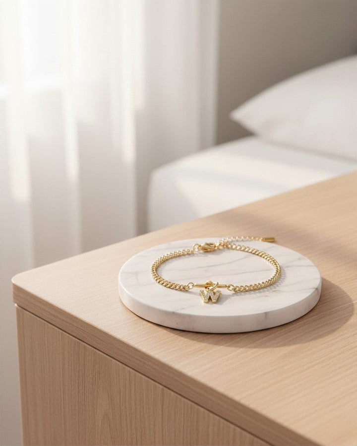 Elli Jewellery gold plated waterproof bracelet featuring a diamante W initial charm on a delicate chain