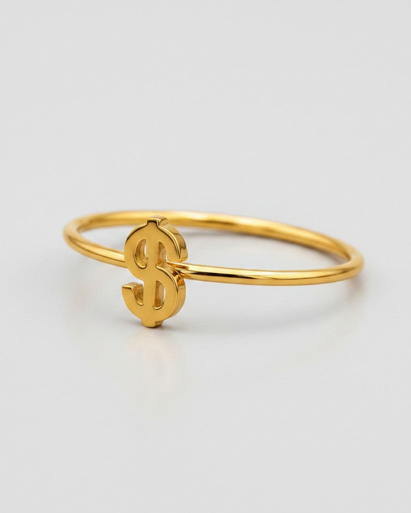 Elli Jewellery gold plated waterproof statement ring featuring a minimalist dollar sign symbol on a thin band.