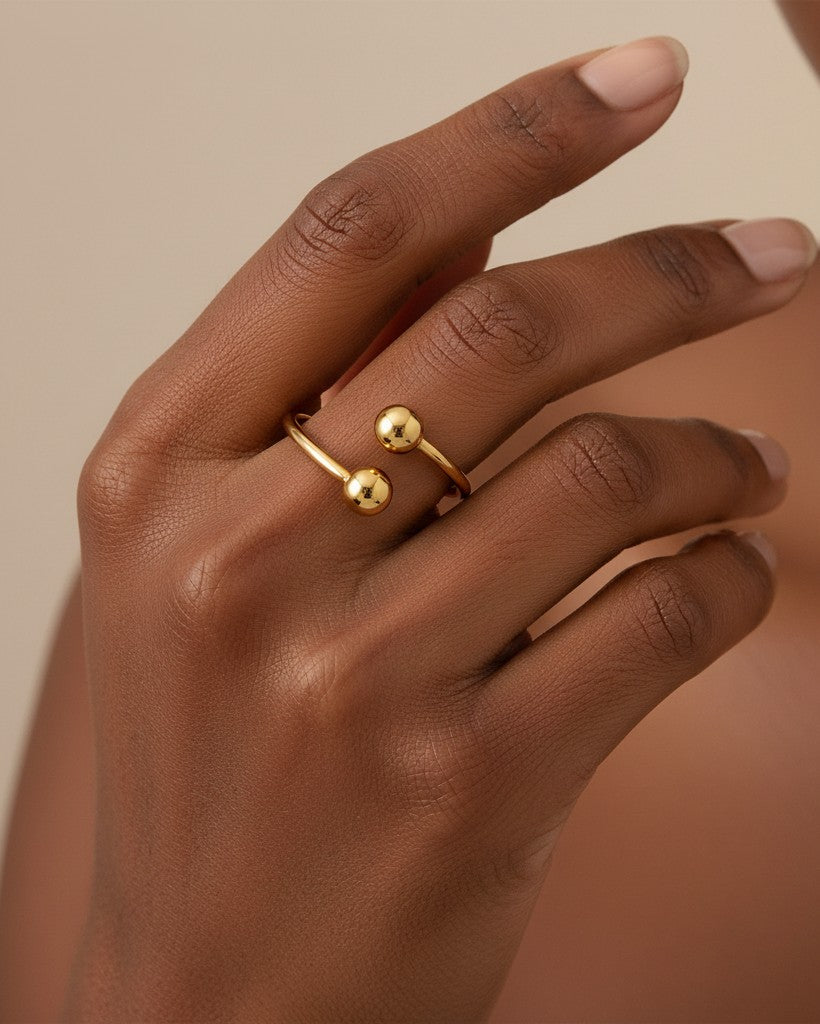 Elli Jewellery gold plated minimalist double ball ring worn on a finger, featuring a sleek, waterproof open design.