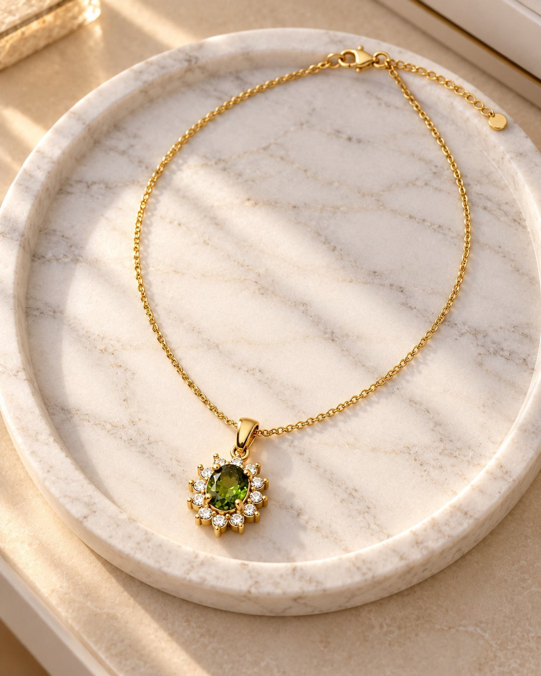 Elli Jewellery gold plated necklace featuring an emerald green crystal teardrop pendant surrounded by small diamonds.