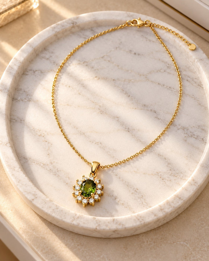 Elli Jewellery gold plated necklace featuring an emerald green crystal teardrop pendant surrounded by small diamonds.