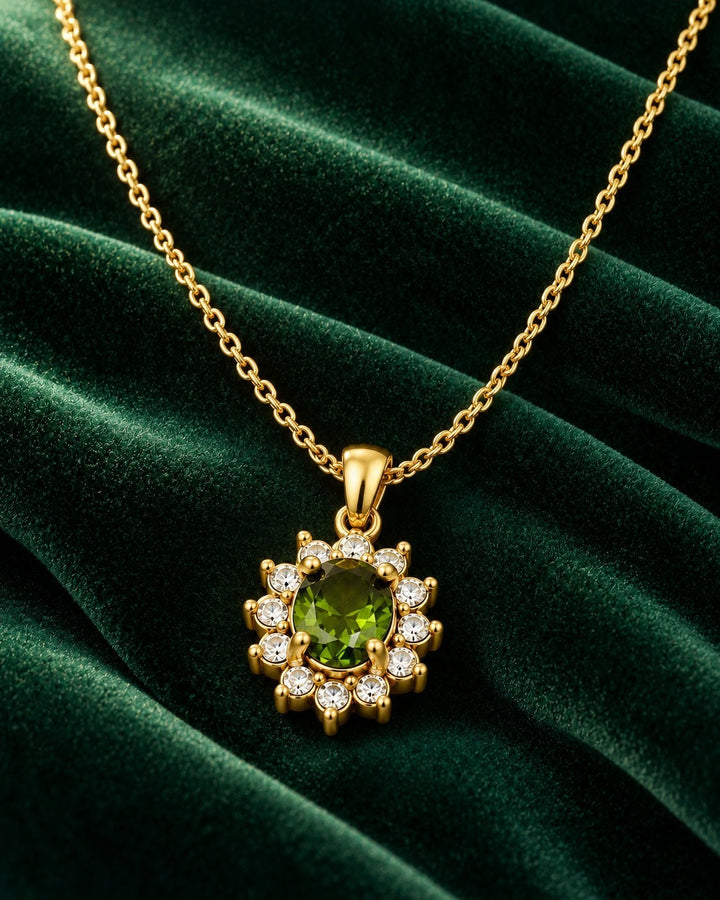 Elli Jewellery gold plated necklace featuring an emerald green crystal teardrop pendant surrounded by clear stones