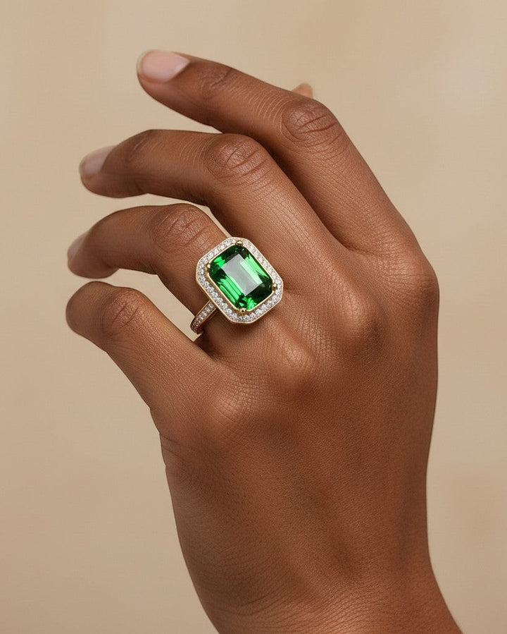 Elli Jewellery gold plated chunky ring featuring a large emerald green rectangular stone with a crystal halo setting.