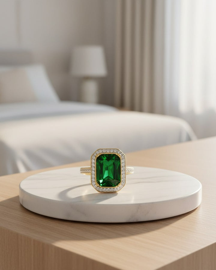 Elli Jewellery gold plated chunky ring featuring a large emerald green rectangle stone with a halo of small crystals.