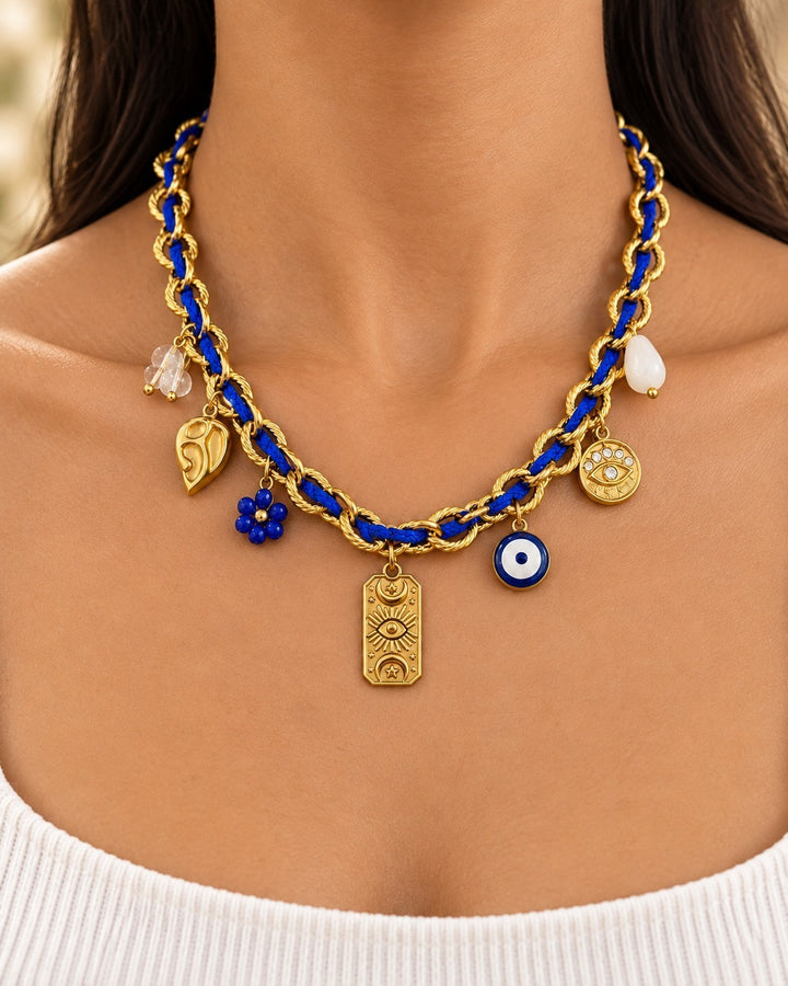 Elli Jewellery gold plated chain necklace featuring blue cord, evil eye charm, and various celestial pendants.