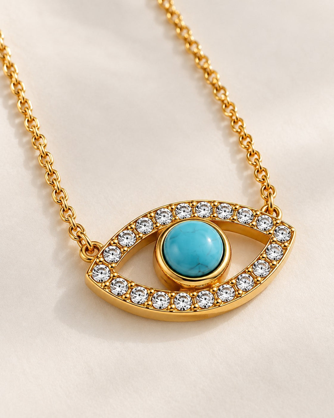 Elli Jewellery gold-plated evil eye necklace featuring a central turquoise stone surrounded by clear zirconia crystals
