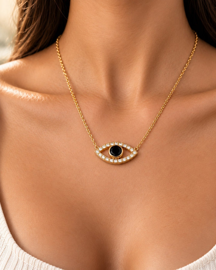 Elli Jewellery gold plated eye pendant necklace with a central black stone and sparkling zirconia crystals on a chain