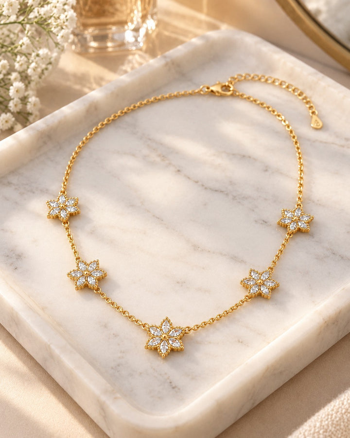 Elli Jewellery gold plated necklace featuring five delicate floral bloom pendants with sparkling white crystals.