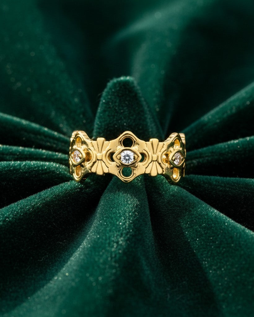 Elli Jewellery gold plated hollow floral statement ring with embedded crystals on a dark green velvet background