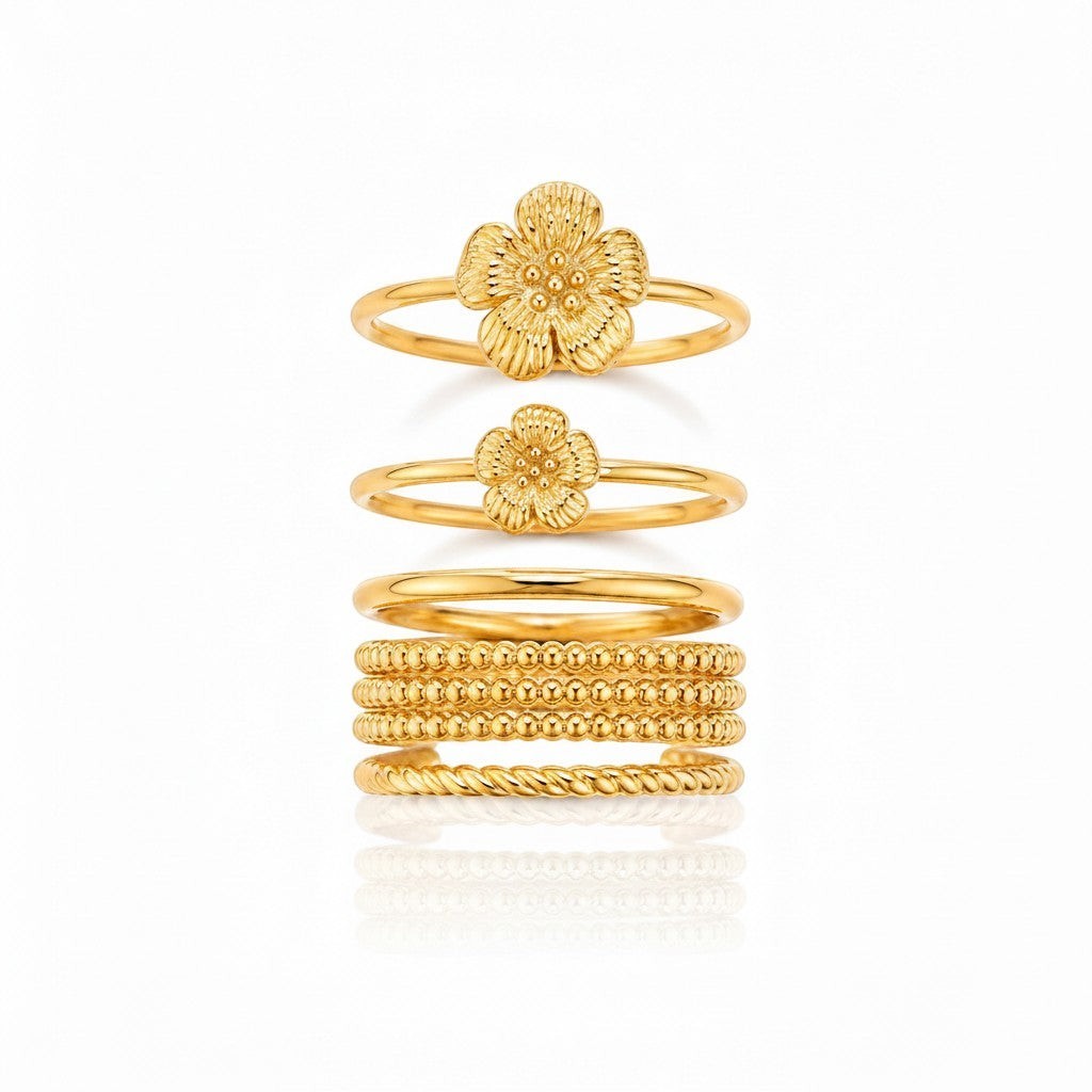 Elli Jewellery gold plated waterproof stacking ring set featuring floral bloom designs and textured bands.