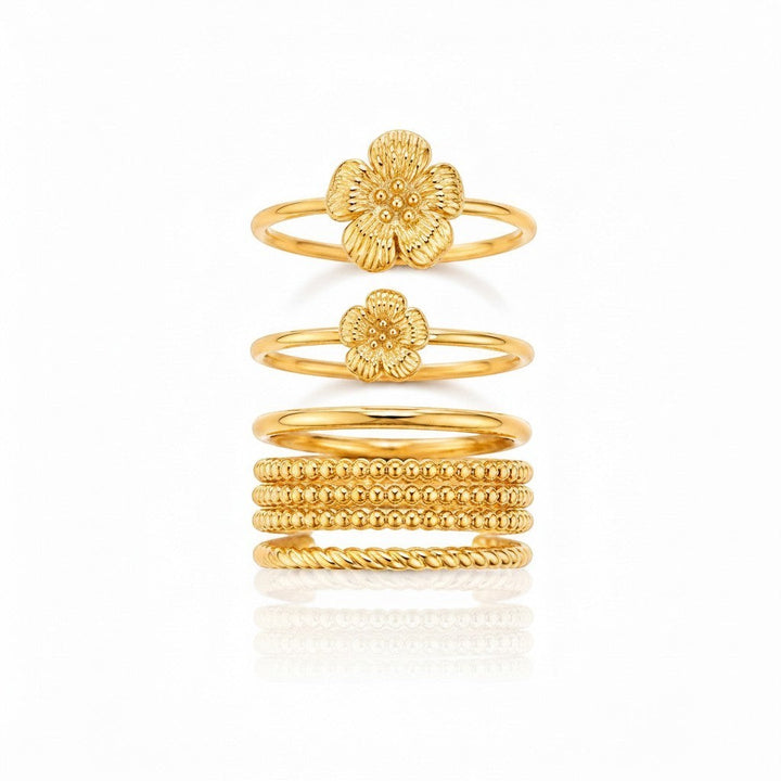 Elli Jewellery gold plated waterproof stacking ring set featuring floral bloom designs and textured bands.