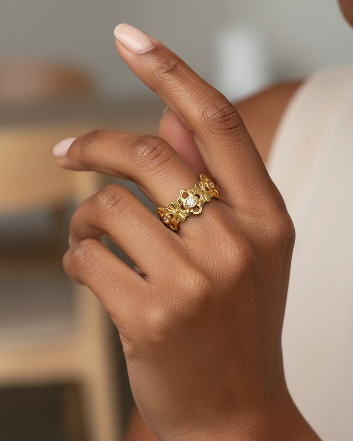 Elli Jewellery gold plated hollow floral statement ring worn on a finger with intricate nature-inspired detailing.