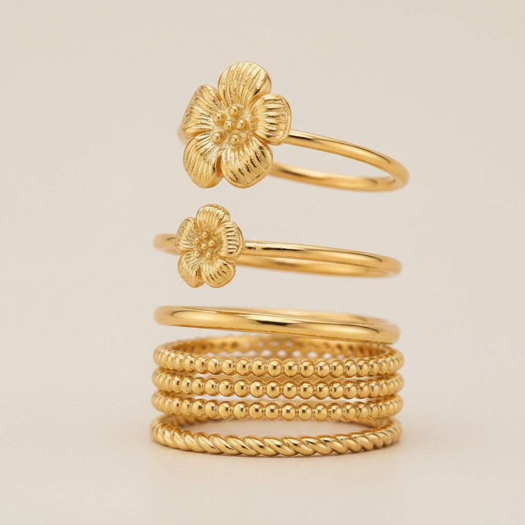 Elli Jewellery gold plated flower ring set featuring delicate floral motifs and textured beaded bands