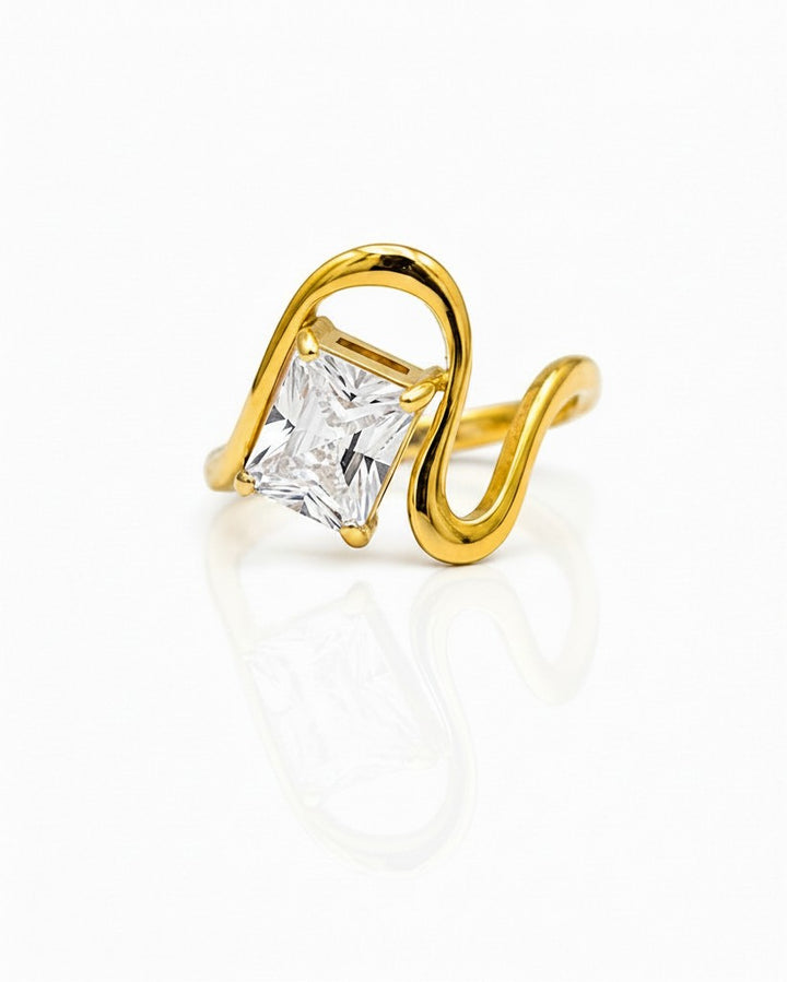 Elli Jewellery gold plated ring featuring a geometric wavy band and a sparkling rectangular cut crystal stone.